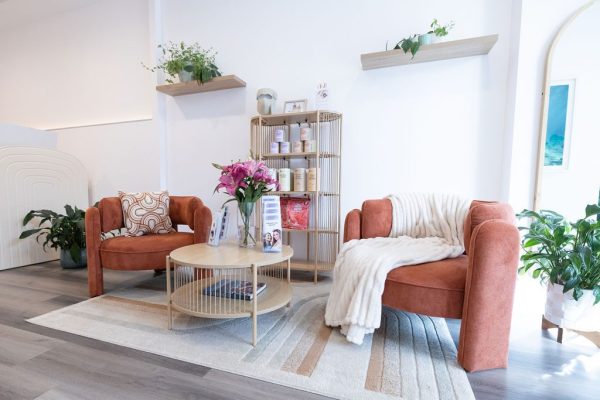Waiting lounge with terracotta armchairs at The Effortless Clinic in Gungahlin