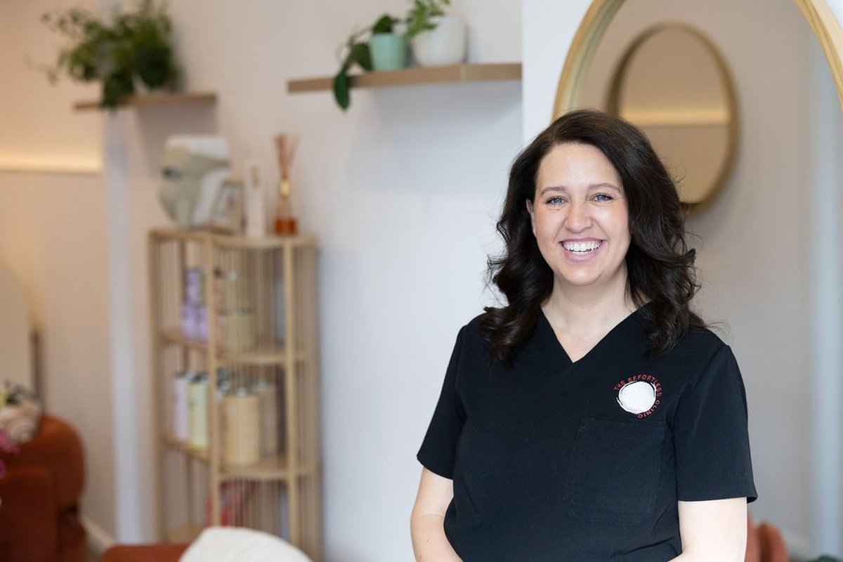 Jacci, owner of The Effortless Clinic in Gungahlin, smiling in the clinic