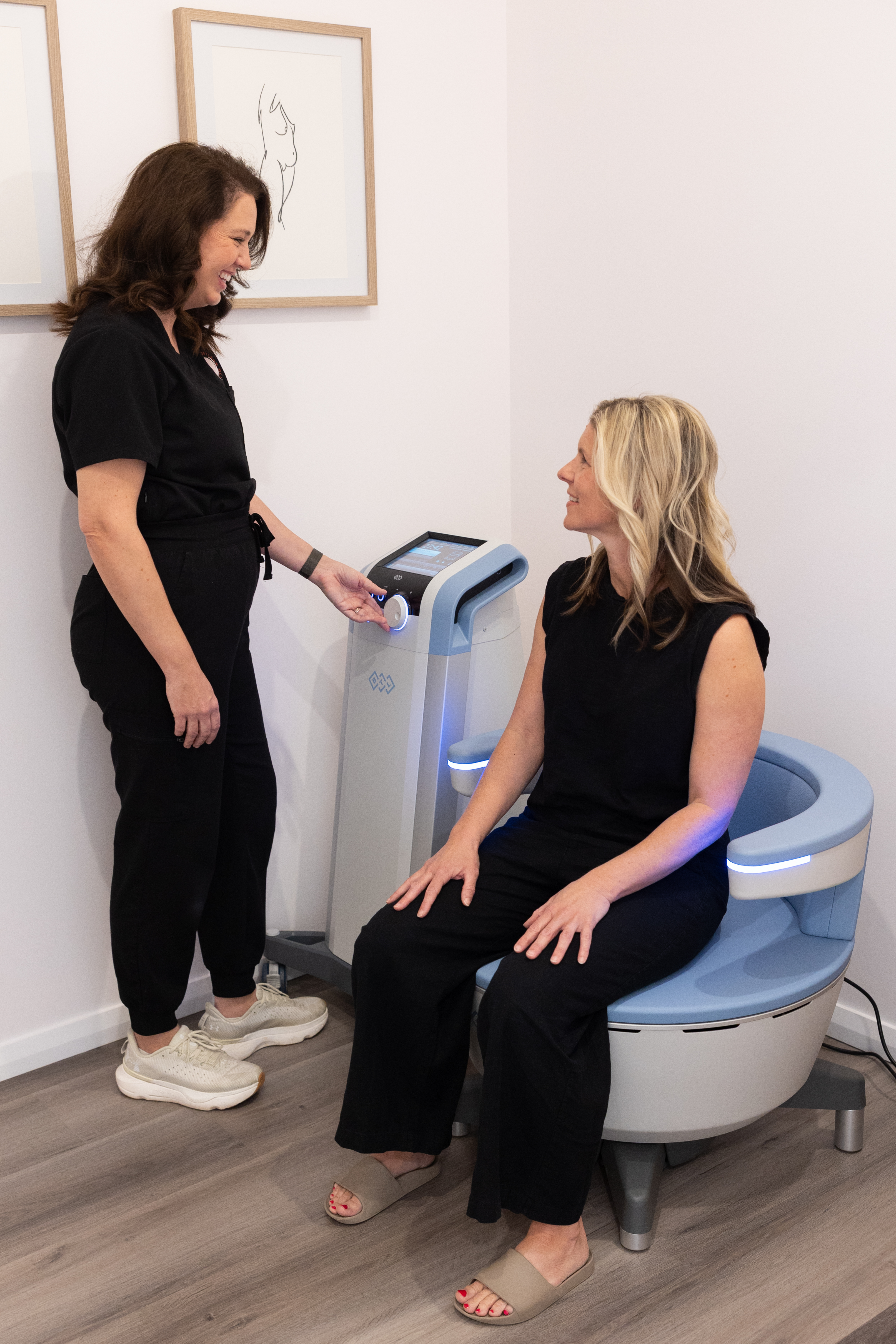 Jacci with a client on the Emsella chair at The Effortless Clinic