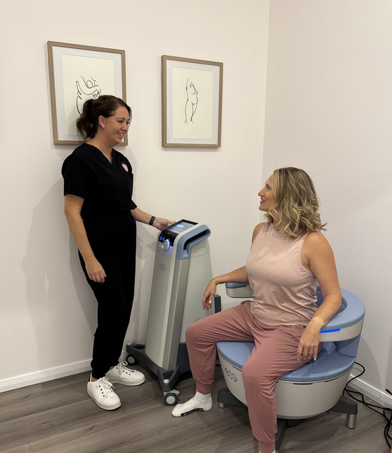 Client seated on the Emsella chair with Jacci at The Effortless Clinic